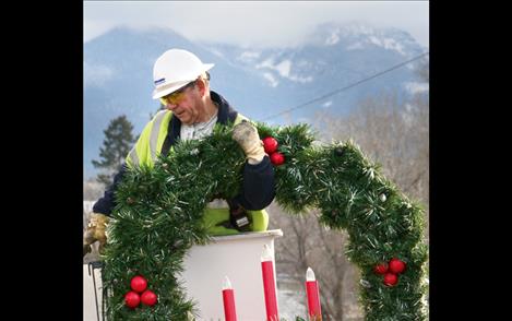 The last of more than 300 wreaths hung during Jim Boyer’s career with Mission Valley Power is mounted Nov. 29 in Polson.