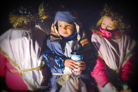 Shepherds and angels brave chilly temperatures to ride on the New Life Church float in the Lake County Parade of Lights Friday night.