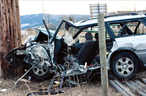 A power pole stopped the Subaru station wagon after the car hit a fence.