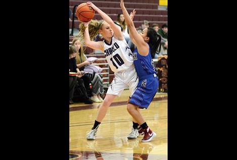 Kaitlin Cox fights off a Clark Fork Lady Mountain Cats defender Friday.