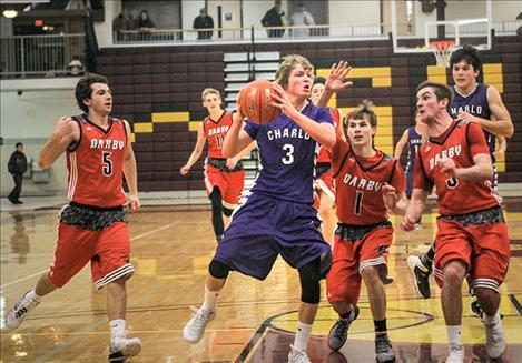 Vikings’ Tyson Petticrew goes up for a score against Darby Tiger defenders Saturday during the Western C Tip- Off tournament in Pablo.