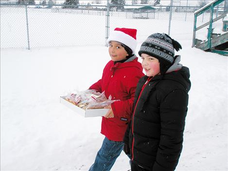 Students walk with cookies to the CSKT law enforcement building on Friday, Dec. 16.