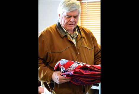 Veteran David Peck receives a Quilt of Valor for his service.