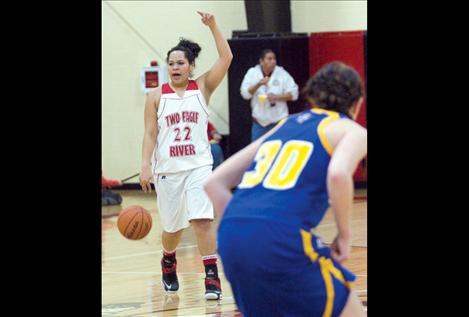 Senior Daryl Conko-Camel calls a play for her teammates as she brings the ball down the court.