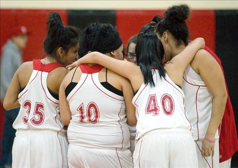 Above: The Lady Eagles huddle before tip-off of their home game against Victor last week.