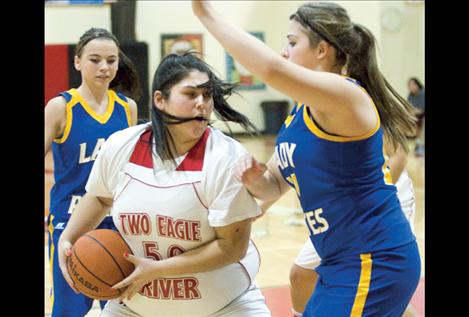 Freshman Tyra Michel grabs a rebound on defense during Friday’s game against the Victor Lady Pirates.