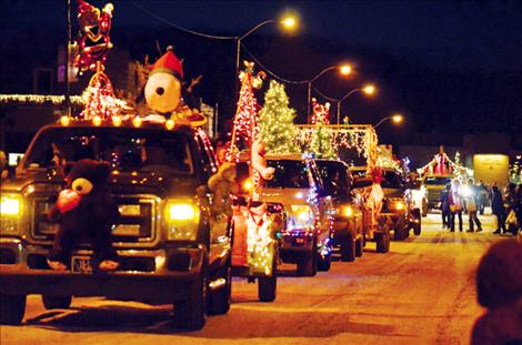 The Ronan Parade of Lights fills Main Street Wednesday evening. Below, a clown entertains.