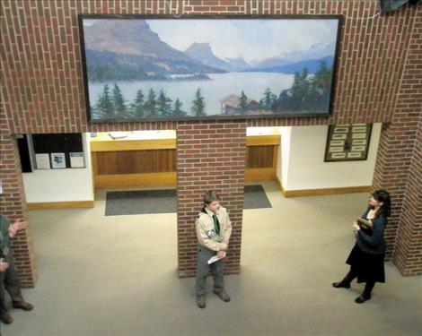 Ethan McCauley stands beneath his Eagle Scout project, a restored mural, at Lake County Courthouse.