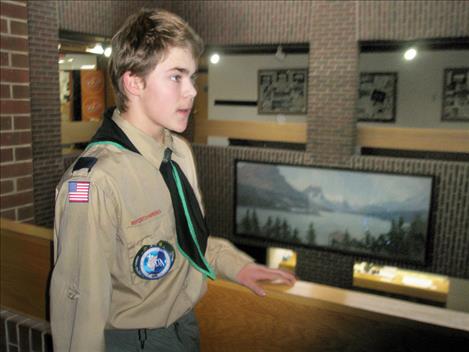 Ethan McCauley speaks about his Eagle Scout project, a mural of St. Mary Lake (in background).