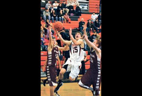 Junior Tim Woll goes up for two points during Friday’s game.