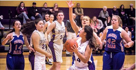 Lady Pirate Olivia Perez drives the lane against Wildkat defenders on Saturday.