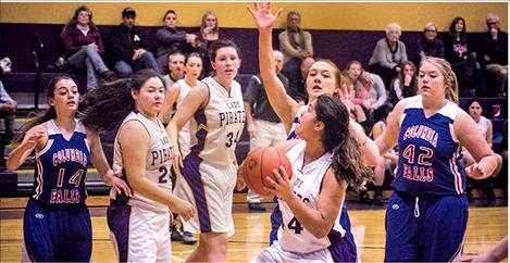 Lady Pirate Olivia Perez drives the lane against Wildkat defenders on Saturday.
