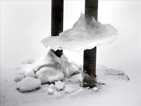 Ice clings to a dock at Salish Point in Polson.