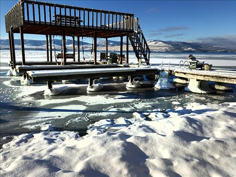 Record rainfall in October kept Flathead Lake water levels high enough in November to cause ice to freeze on docks, despite extra water being released from SKQ dam during the past three months, according to Brian Lipscomb of Energy Keepers. The water level is currently at a normal height for January.