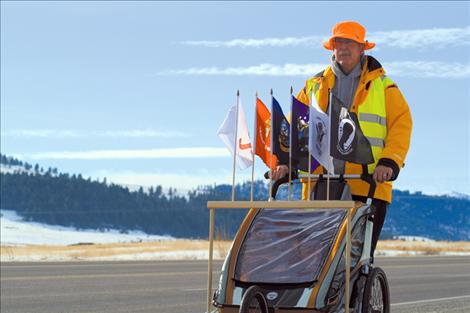 Decked out in bright reflective clothing, Ronan resident and Marine veteran Chuck Lewis trains along U.S. Highway 93 in preparation for his 3,300-mile walk across America.