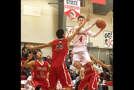 Arlee’s Phillip Malatare flies high for two points against Two Eagle.