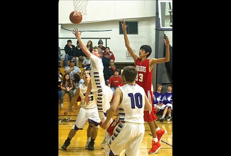 Charlo’s Tyson Petticrew slips past an Arlee defender.