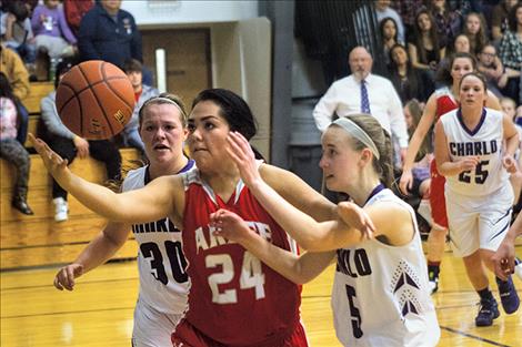 Scarlets’ Alyssia Vanderburg battles Charlo defenders for the ball.
