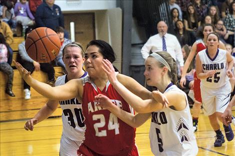 Scarlets’ Alyssia Vanderburg battles Charlo defenders for the ball.