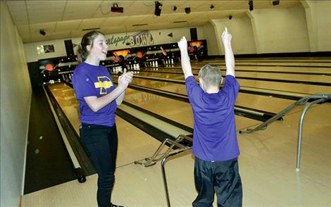 Megan Rost celebr ates a strike.