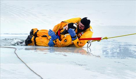 Jon Thorsted pulls volunteer “victim” Trina Nethercott from the frigid water of Flathead Lake.