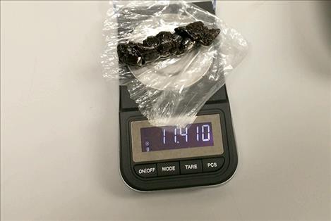 Law enforcement officers weigh one chunk of heroin confiscated from a Lake County residence Jan. 29. The combined amount confiscated weighed more than 12 grams.