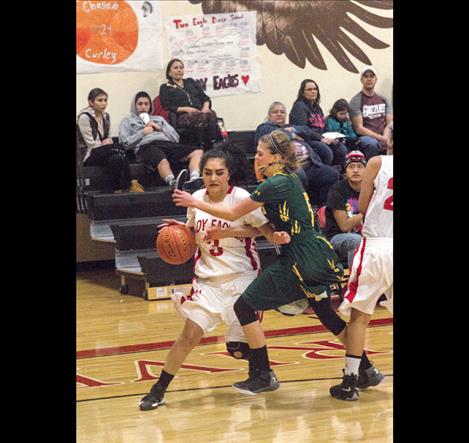 Lady Eagles’ Esperanza Orozco battles past a St. Regis defender Friday in Pablo.