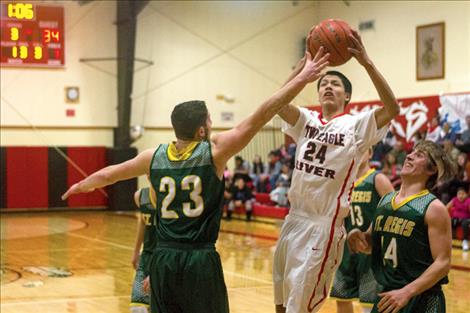 Two Eagle River’s Chasen Curley drives toward the hoop against the Tigers’ defense Friday at home.