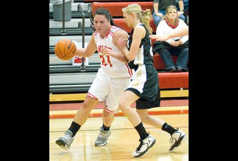 Senior Mahalia Hendren, a team leader for this year’s Arlee Scarlets, drives to the basket around a Seeley-Swan defender earlier this season.