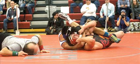 Mission’s Trent Dennison wrestles in the championship round, winning by decision.