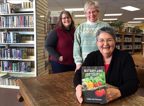 Author Linda Lieb Peterson will sign her book “Nutrify and Detoxify: Manage Today’s Health Challenges,” at the North Lake County Public Library. Supporting Peterson are Library Director Marilyn Trosper, center, and Assistant Director Abby Dooley.