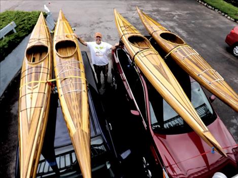 Gary Teggeman stands with four of his handcrafted cedar kayaks. A drawing for the one on the far left will take place at Mission Valley Aquatic Center on Sunday, Feb. 26.