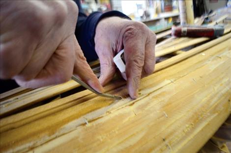 Gary Teggeman pull stapes from thin strips of cedar.