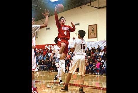 Warriors’ Phillip Malatare soars above the Eagles’ defense.