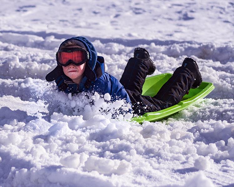 Indy Groves of Polson comes to an abrupt halt after an epic run down the hill at Riverside Park on Saturday.