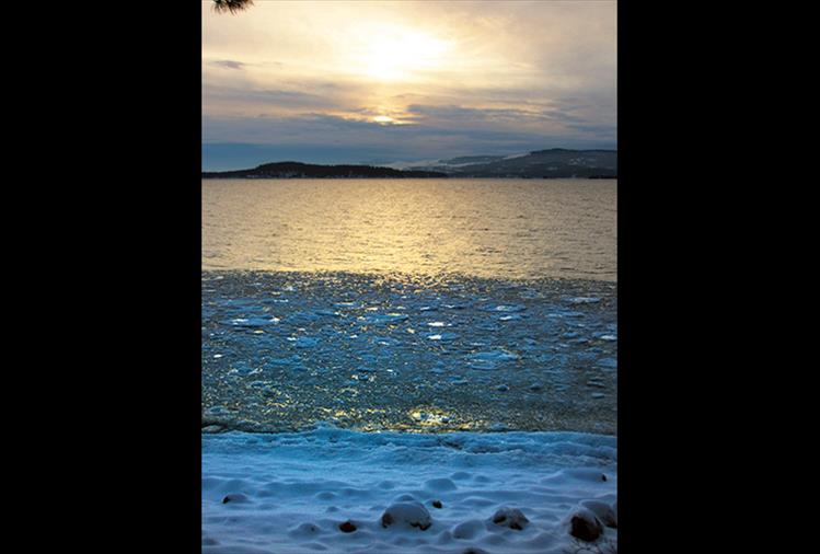 Sunrays cast an icy glow on the surface of the East Shore of Flathead Lake.