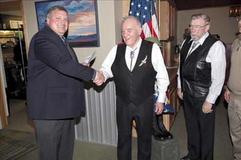 William Squires, of Blackfoot Telecommunications, presents a check for $3,000 to museum founder Bud Cheff Jr. and board chair Rod Wamsley.