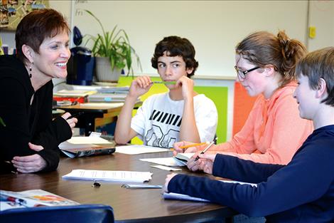 Linda Jones discusses book themes with Ronan eighth-grade students.
