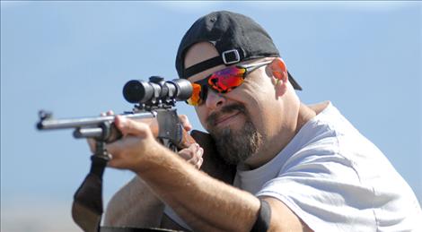 A gun owner sights in a firearm at the Polson Shooting Range in 2011.