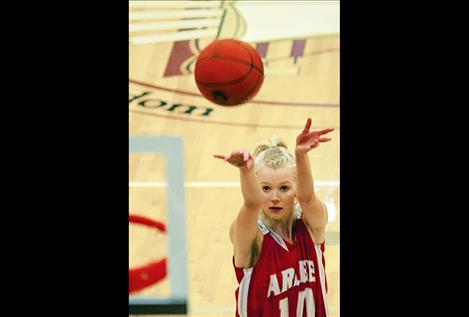 Carly Hergett shoots a free throw for the Scarlets during district tournament action.