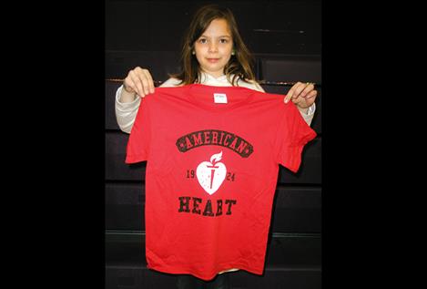 Linderman Elementary second-grader Adin Hunt holds a t-shirt at last week’s Jump Rope for Heart event.