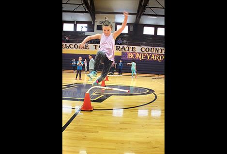 Clarissa Allen jumps over hurdles during the Jump Rope for Heart event at Linderman Elementary School.