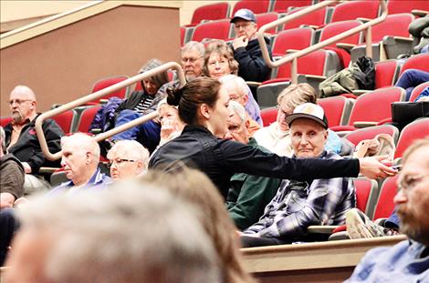 Veyanna Curley-Webster, Ronan High School sophomore, collects questions from the audience.