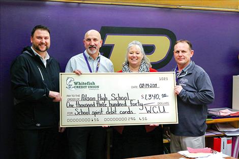 Polson High received $5 for every Whitefish Credit Union debit card issued that featured the Polson Pirates, totaling $1,340. Pictured from left are Eldon Tilley, Whitefish Credit Union's vice president of marketing; Jay Sampson, Polson High School's assistant principal; Lisa Stover, Whitefish Credit Union's Polson branch manager; and Scott Wilson, Polson High School's principal. 