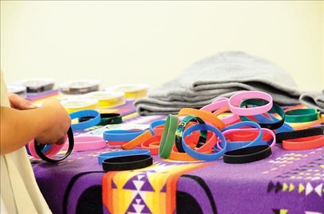 Bracelets are embedded with encouraging words, “Find reasons to live,” and the phone number for the National Suicide Hot Line.