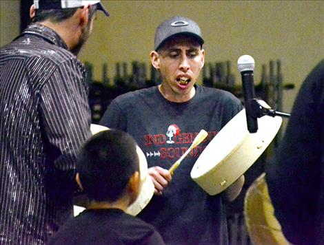 Featured singer Nakoa Heavyrunner leads the drumming.