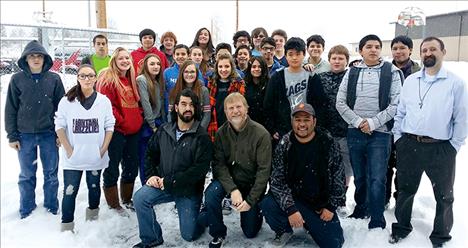 JP Thomas, Lynn Lapka, and Tony Bossy from Cornerstone Pizza, front, are surrounded by Middle School students.