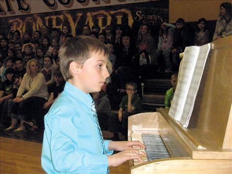 Third-grader Ruger Ellis plays the piano.