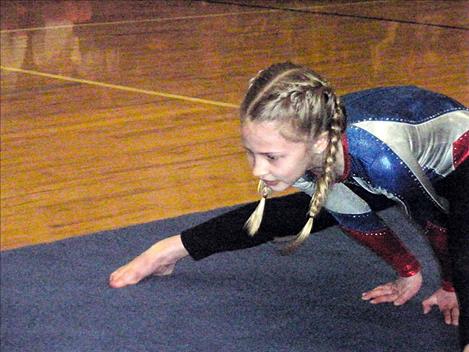 Second-grader Olivia Valentine performs a gymnastics routine.