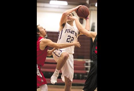 Pirates’ Tanner Wilson drives between two defenders.